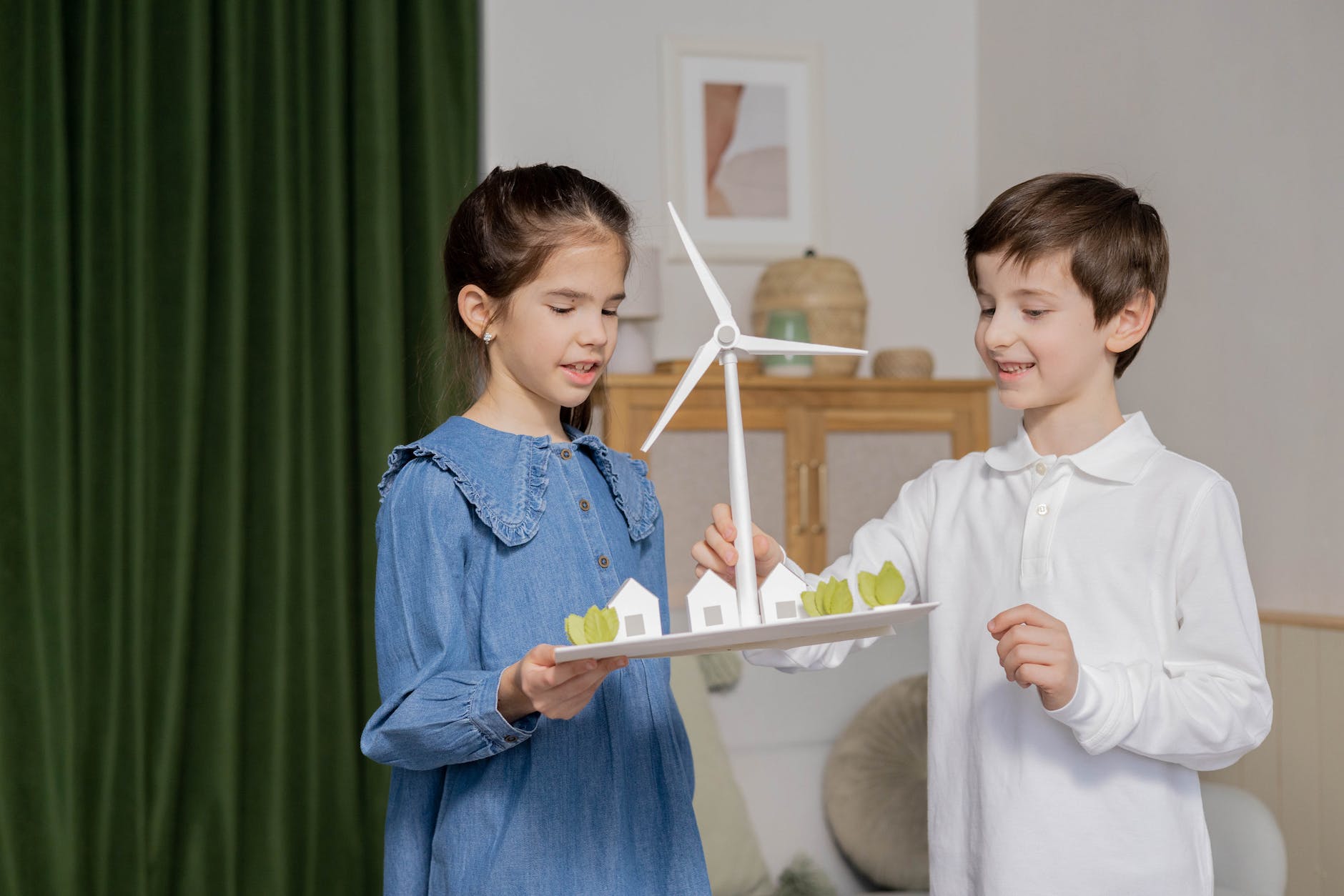 children carrying a wind turbine diorama